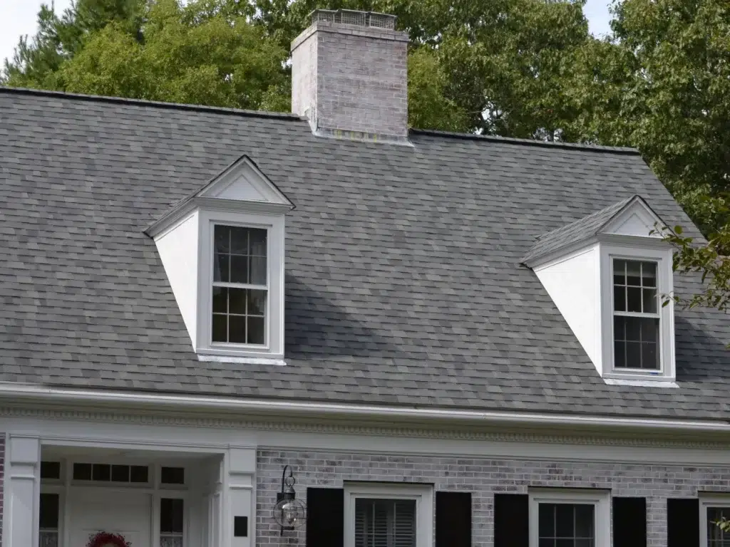 White washed brick home With Roof Replacement