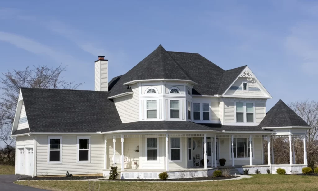 White Victorian with new roof by O'lyn Roofing in Belmont